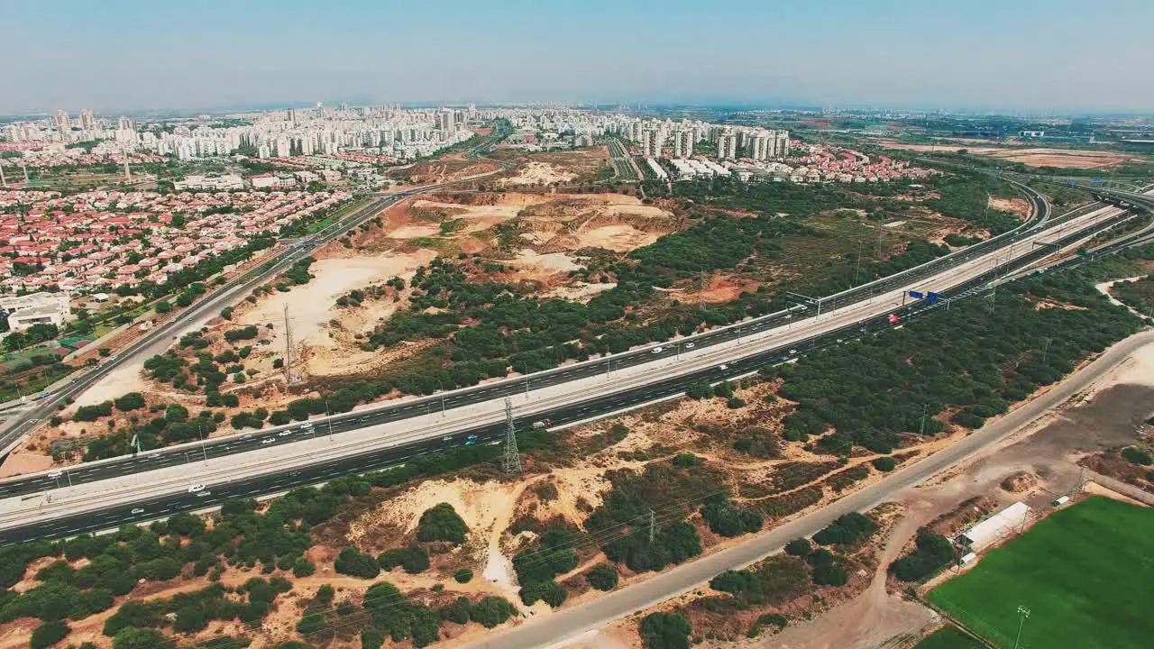 Aerial of a freeway with city background