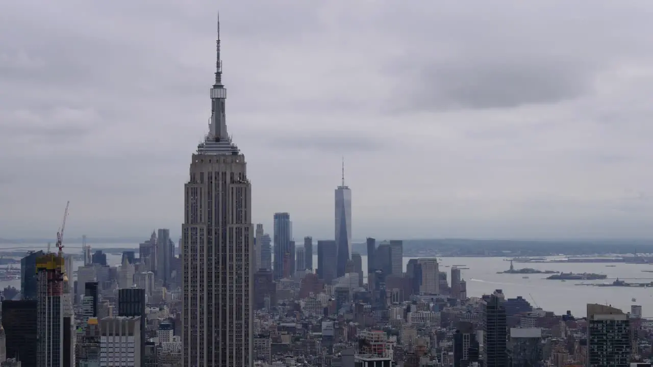 Time Lapse of clouds over the Empire State Building and One World Trade Center and boat traffic on Hudson River in the background which leads to the Island of Liberty in New York City June 2019