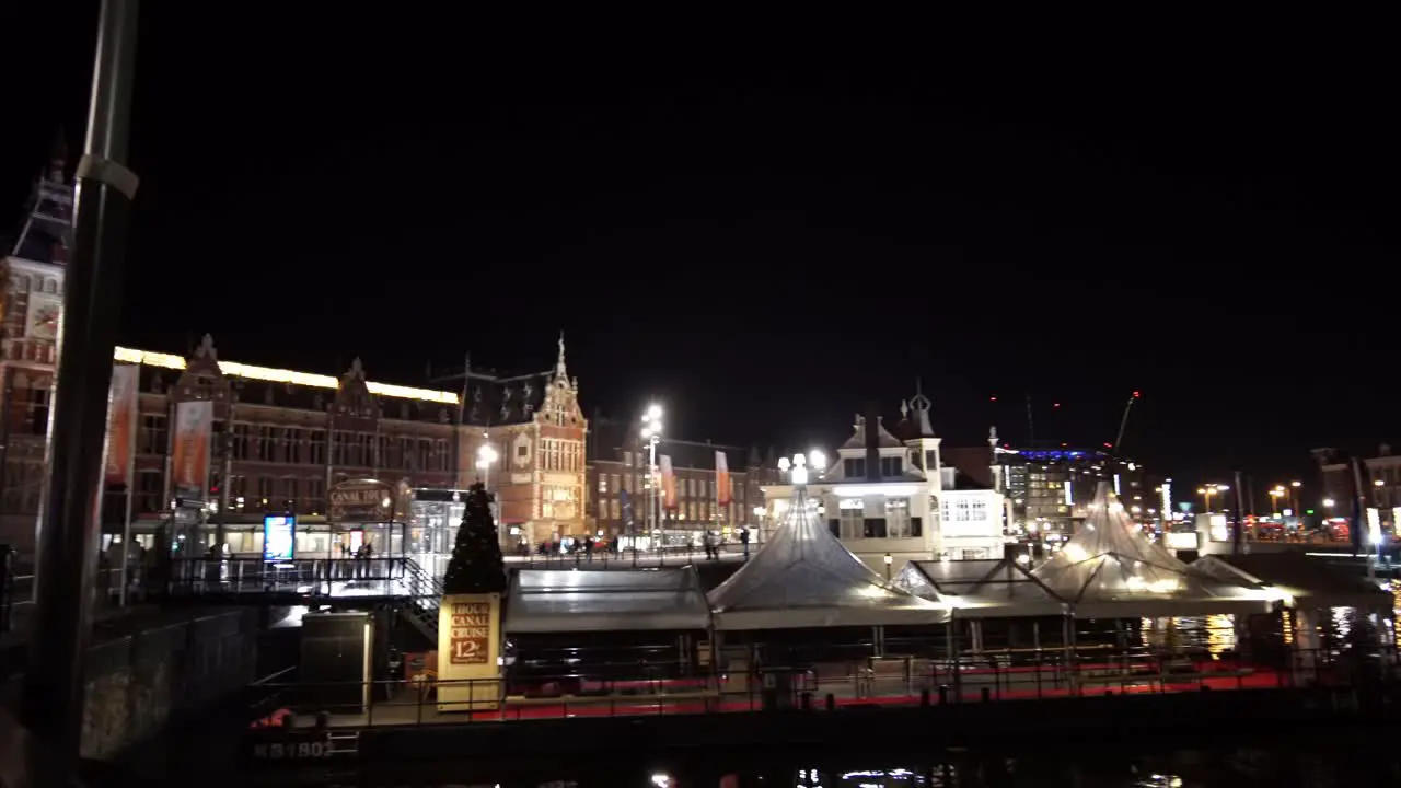 The beautiful city center of Amsterdam at night with the dam square and central station