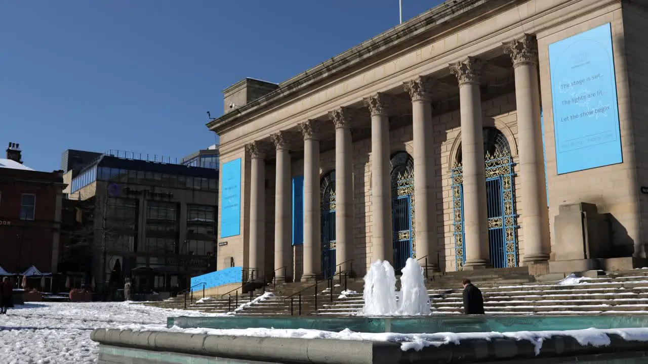 Fountain water feature in front of city hall on a sunny snowy day Sheffield