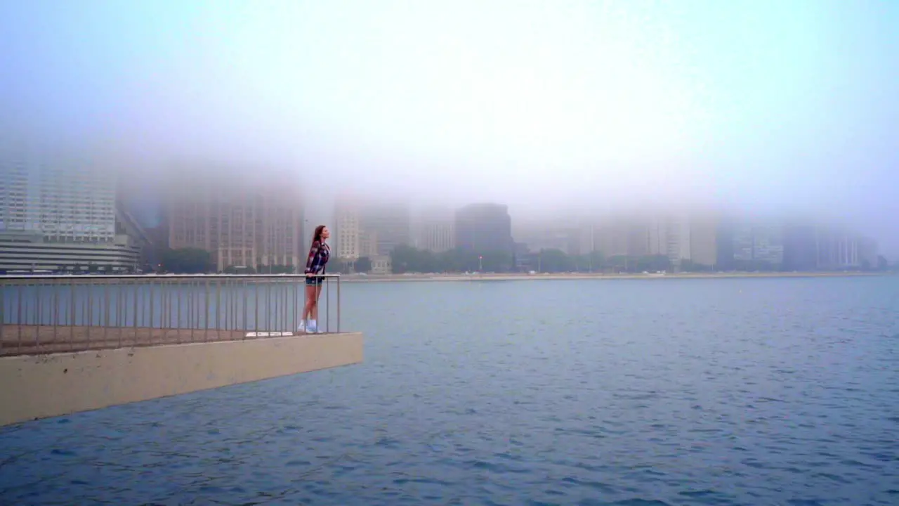 Beautiful woman standing on pier sea city Woman waiting at sea city