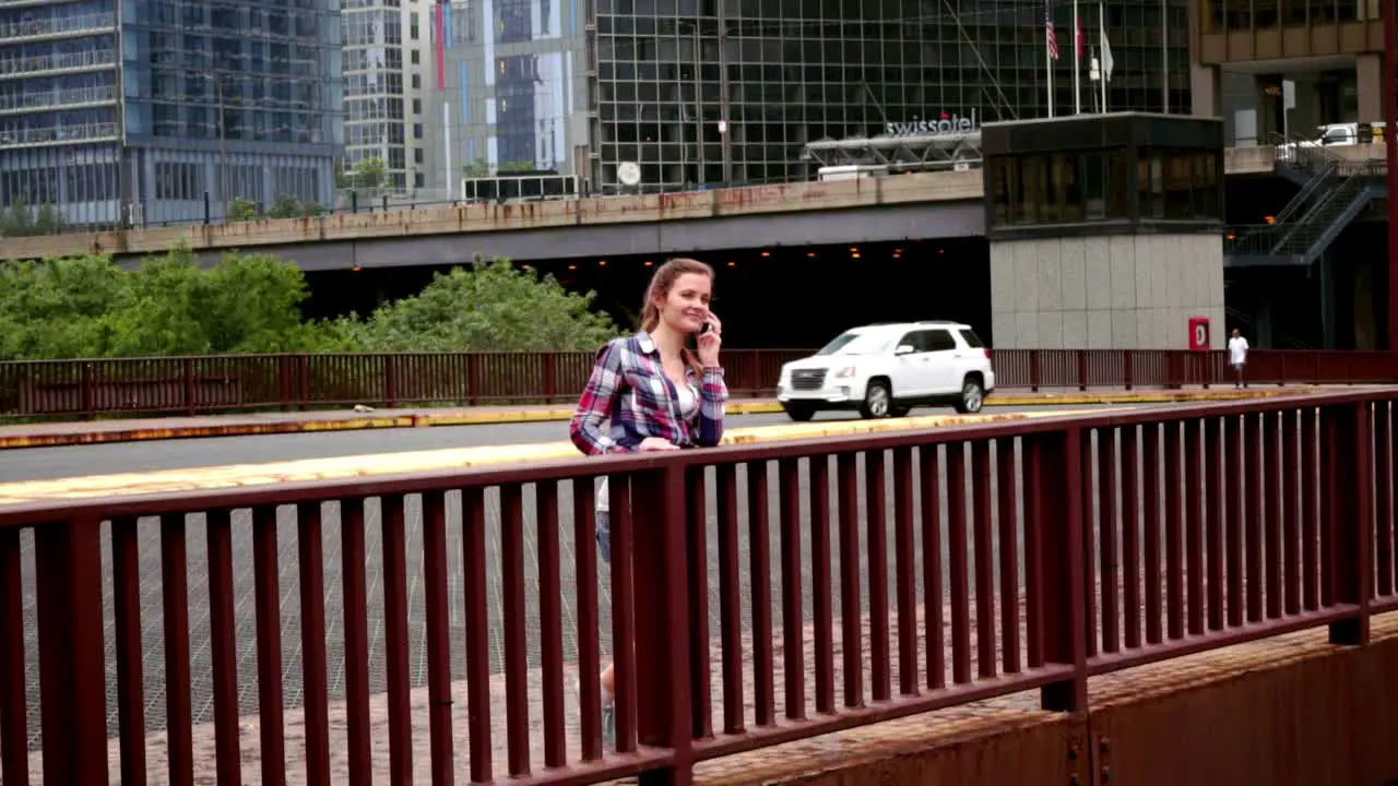 Young beautiful woman talking phone Woman speaking phone on bridge city