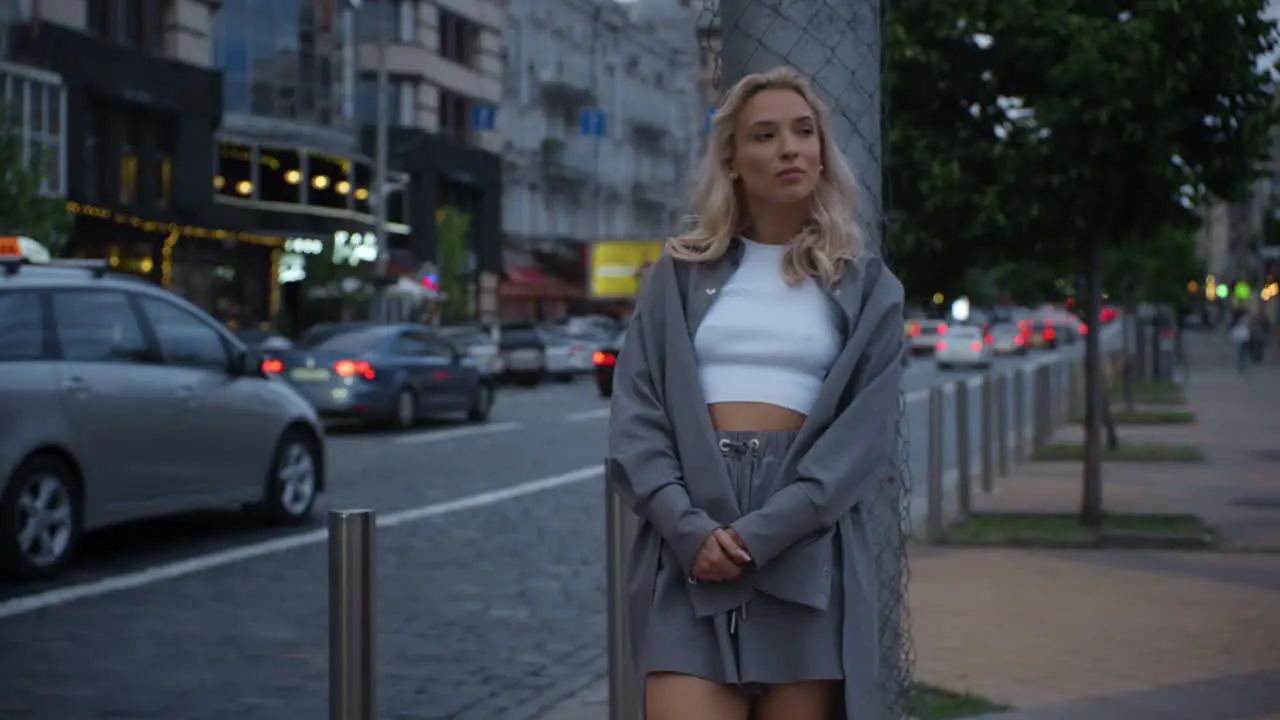 City girl standing highway or road with driving cars at evening