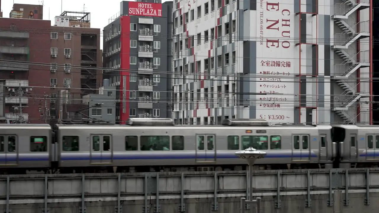 Osaka Loop Line Train Going Past Shinsekai Neighbourhood In Osaka