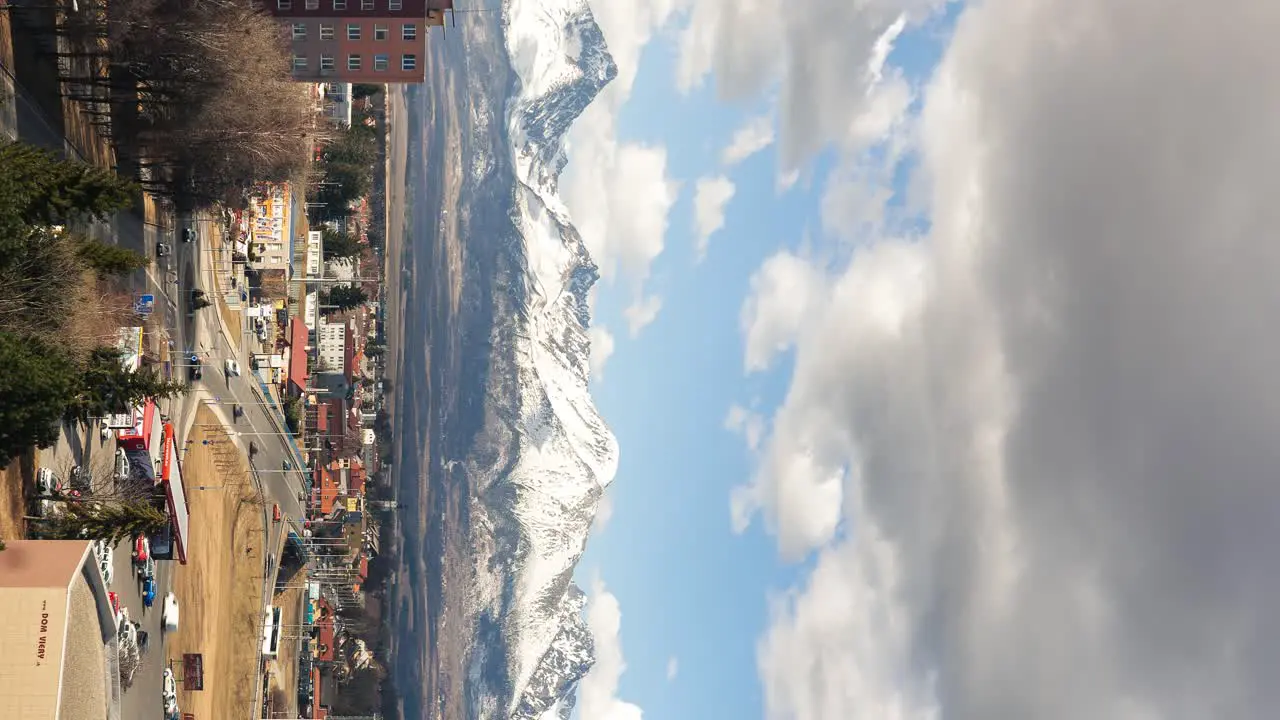 Mountains and city vertival time lapse sunny weather