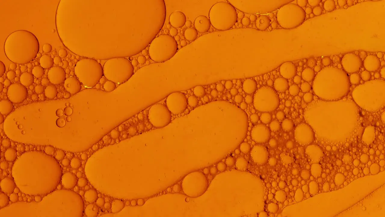 abstract oil drops background in orange liquid for cosmetic treatments Hydroge