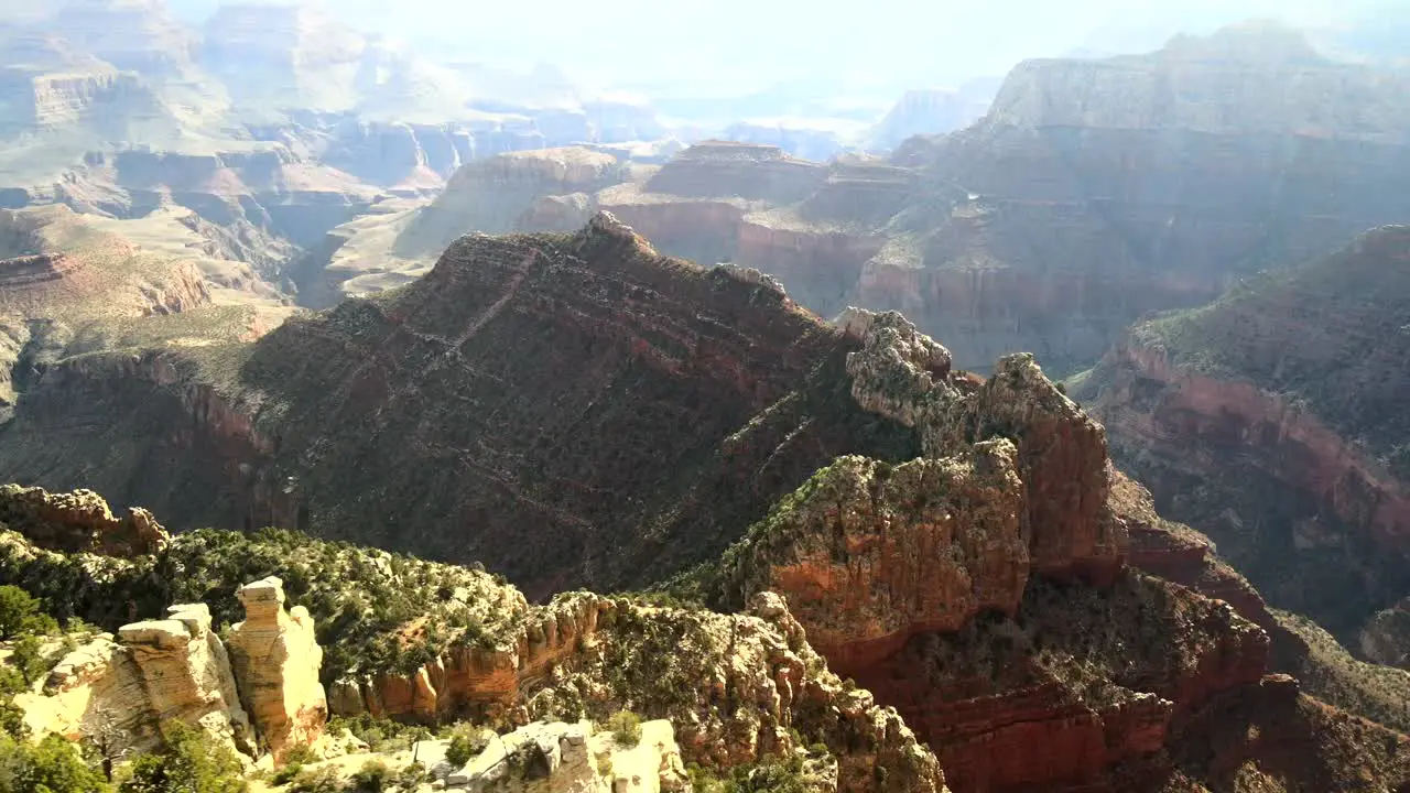 A cinematic view capturing the beautiful play of lights on the rocky hills of the Grand Canyon within the mountainous terrain