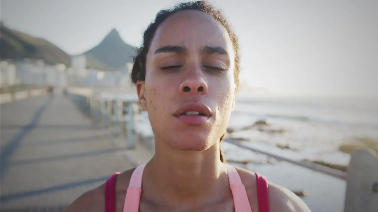 Spots of light against close up of tired african american fit woman taking a break from running