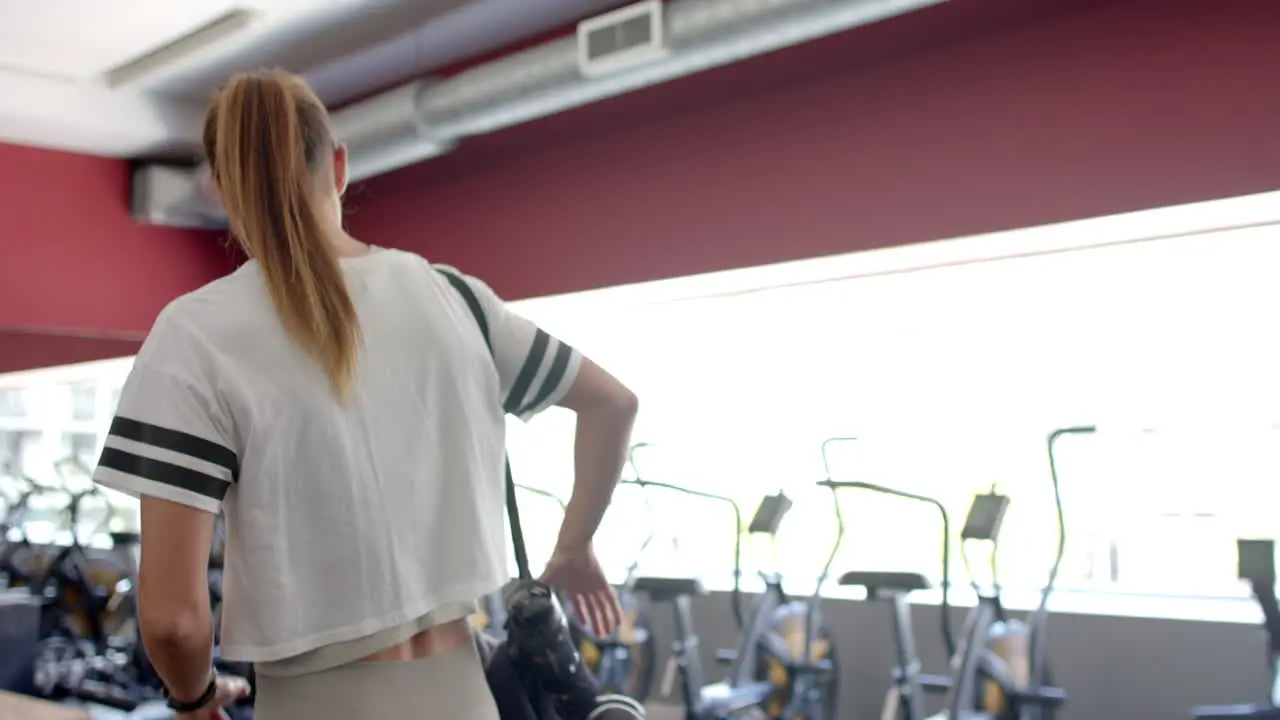 Young Caucasian woman at the gym with copy space