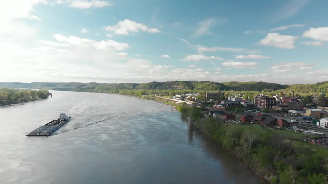 Small town on river with barge landscape dolly 4K