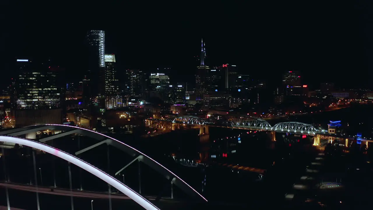 Beautiful night aerial of Nashville TN moving over Korean Veterans bridge 4K