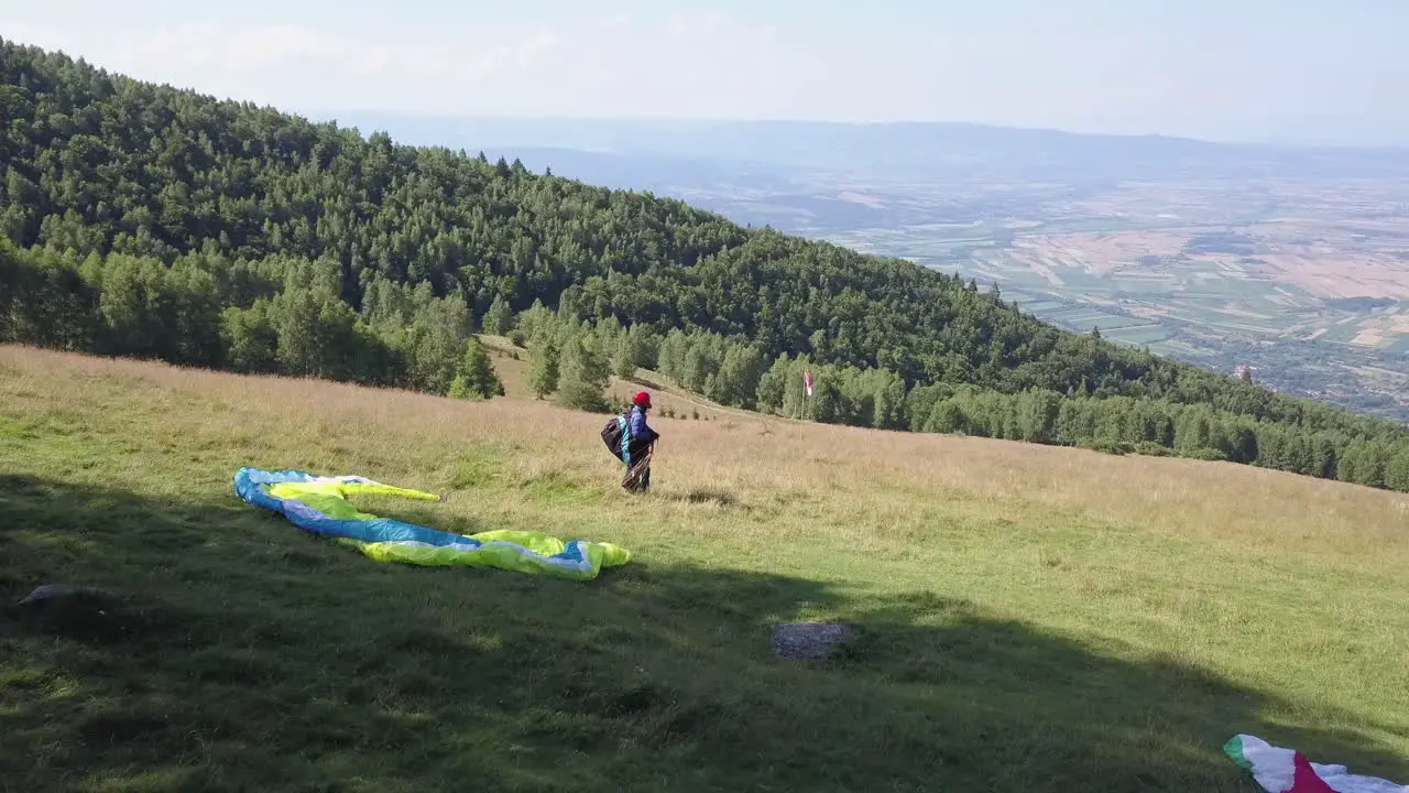 Athlete paraglider waiting for the wind to get stronger to fly