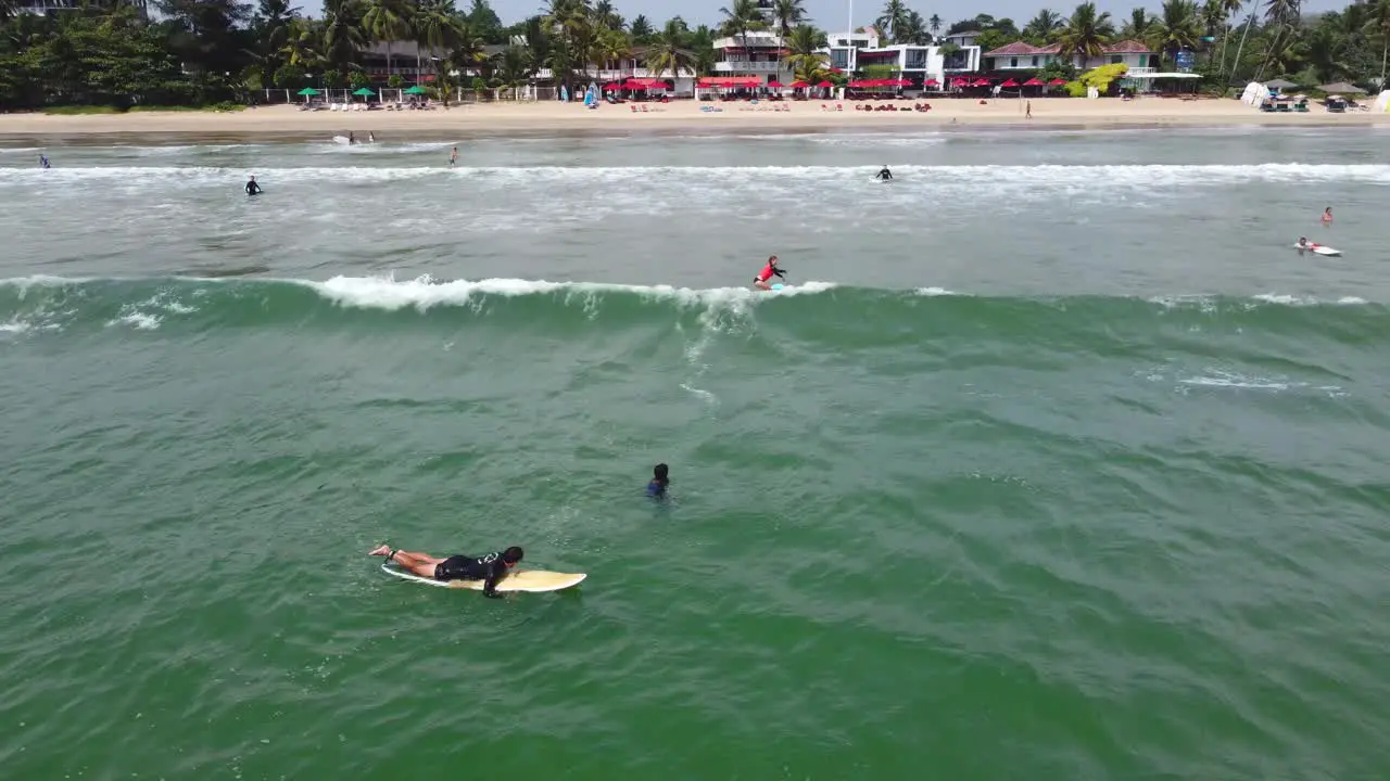 Tracking Shot Of Girl Surfing shallow Wave In Mirissa Beach Sri Lanka