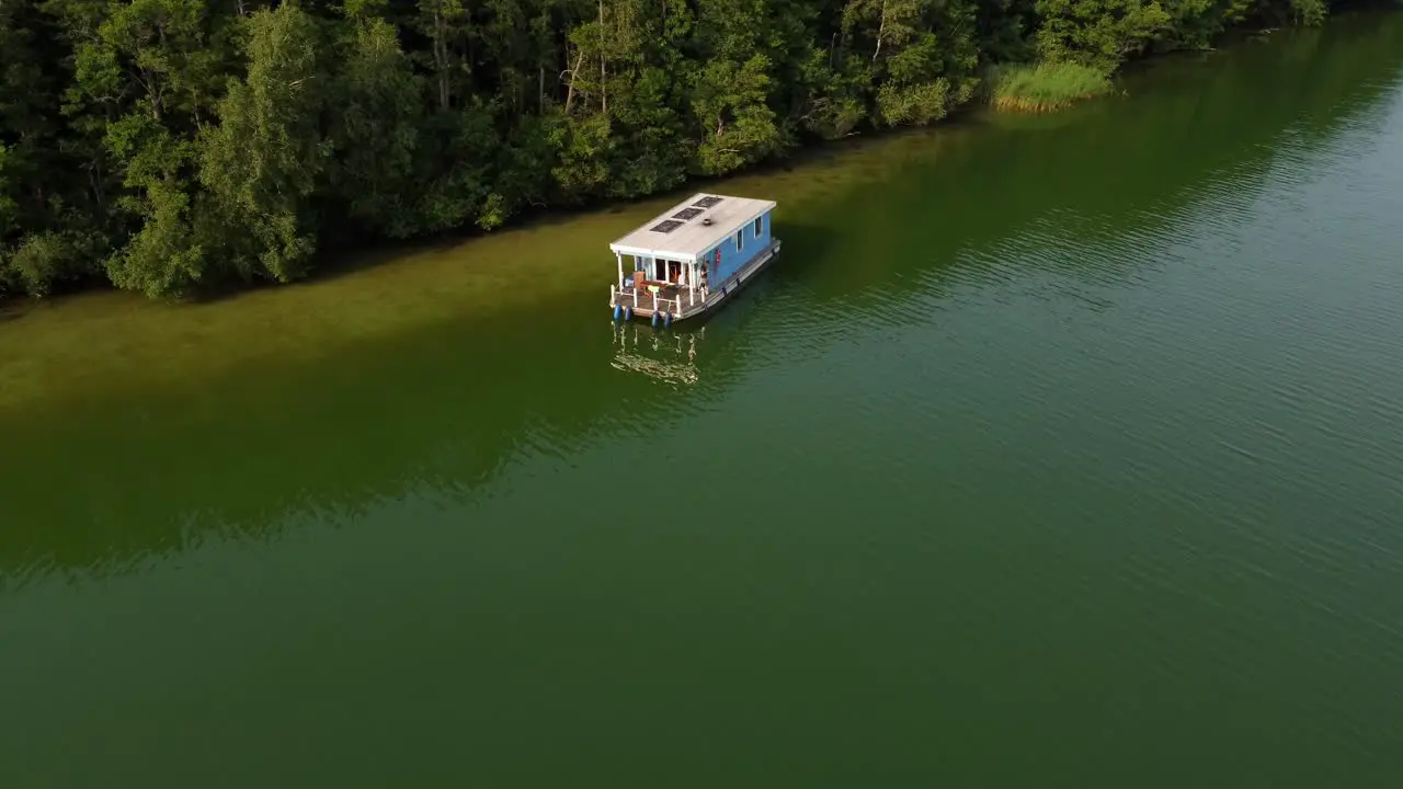 Several motor boats driving on a green natural lake next to a forest in Brandenburg Germany