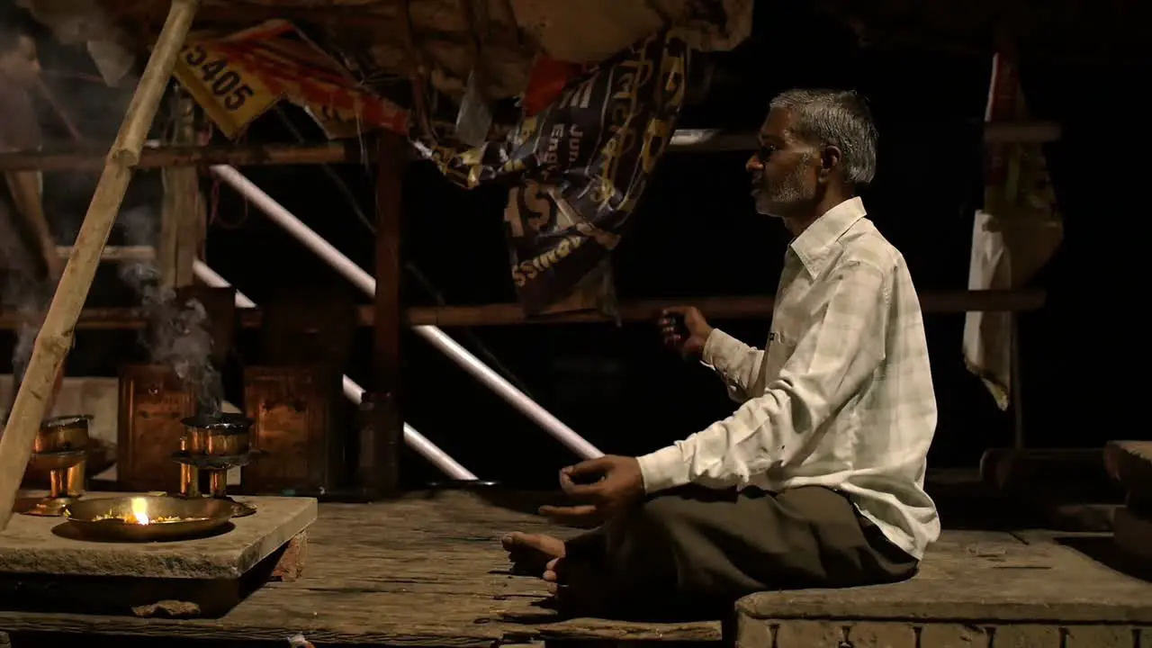 Cross-Legged Man Partaking in Ganga Aarti