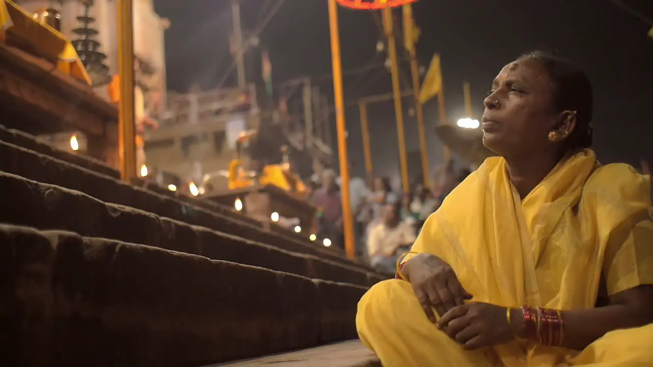 Elderly Woman Sitting on Ghats at Night