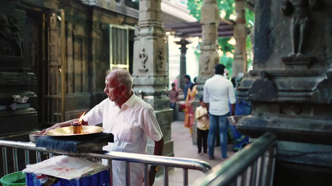 Hindu old man praying in a temple