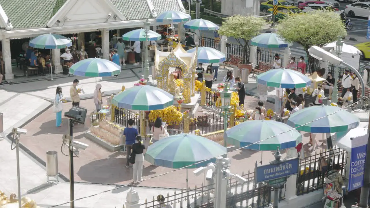 people visit and worship Erawan Shrine at the popular Ratchaprasong intersection on Ratchadamri Road in Bangkok