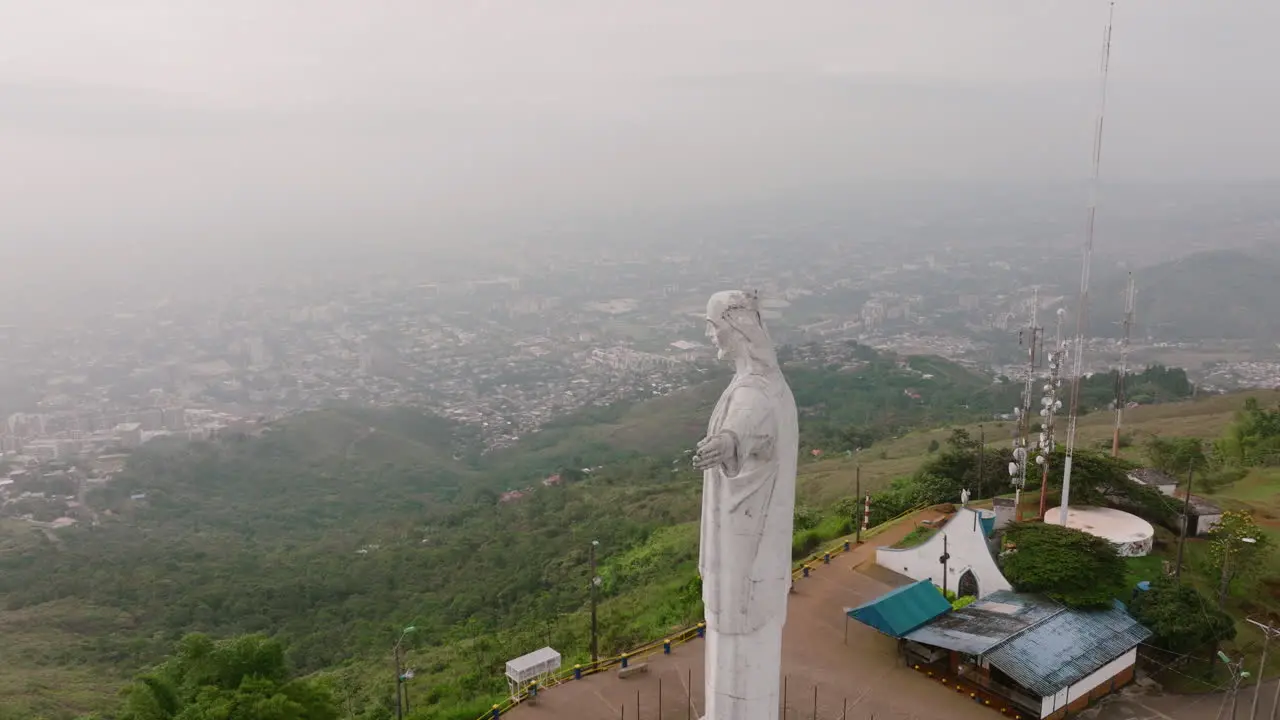 Fast rotating aerial footage of the Cristo Rey Jesus statue on top of a mountain in the city of Cali Colombia