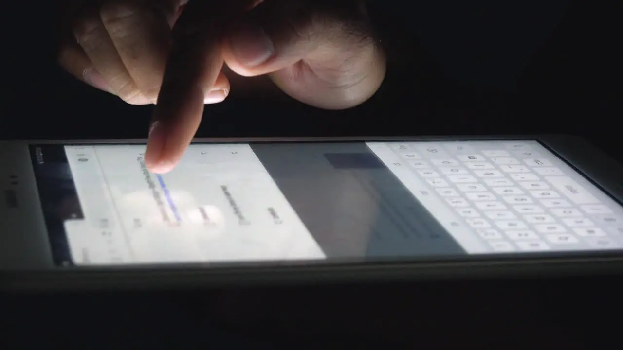 Close Shot of a Man Typing on a Tablet