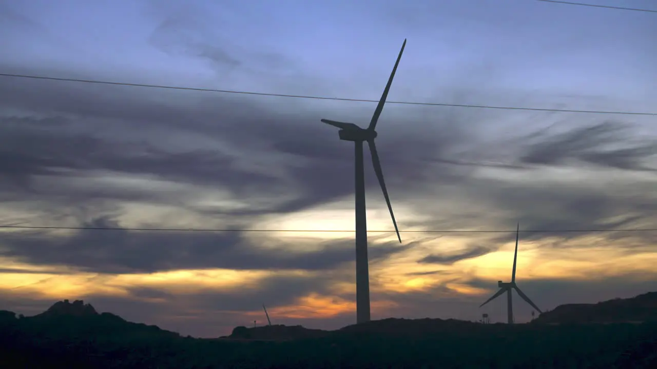 Wind turbines in slow motion after sundown