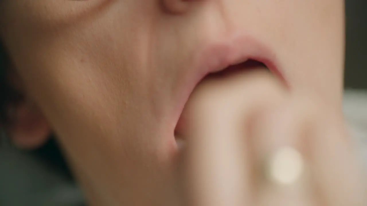 Close-up shot of women taking a swab in the back of the mouth and nose carrying out a Covid-19 rapid antigen self home test