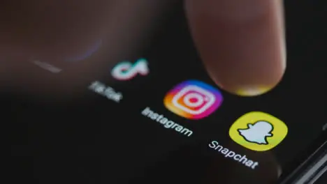 Close Up Shot of Finger Tapping Snapchat On Smartphone Screen