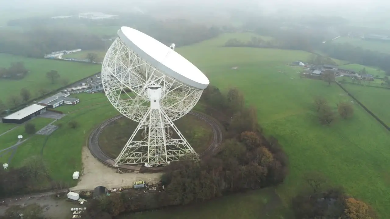 Aerial Jodrell bank observatory Lovell telescope misty rural countryside rear view orbit right