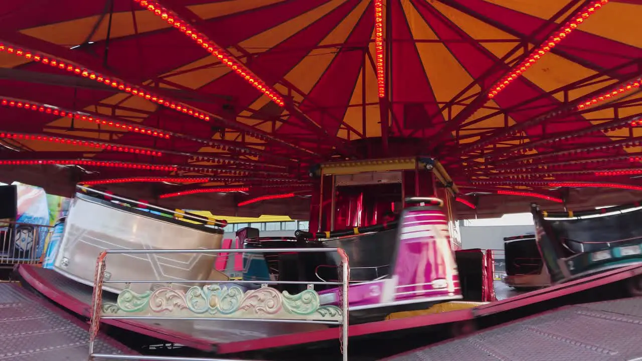 Empty rotating carousel One men inside flashing lights