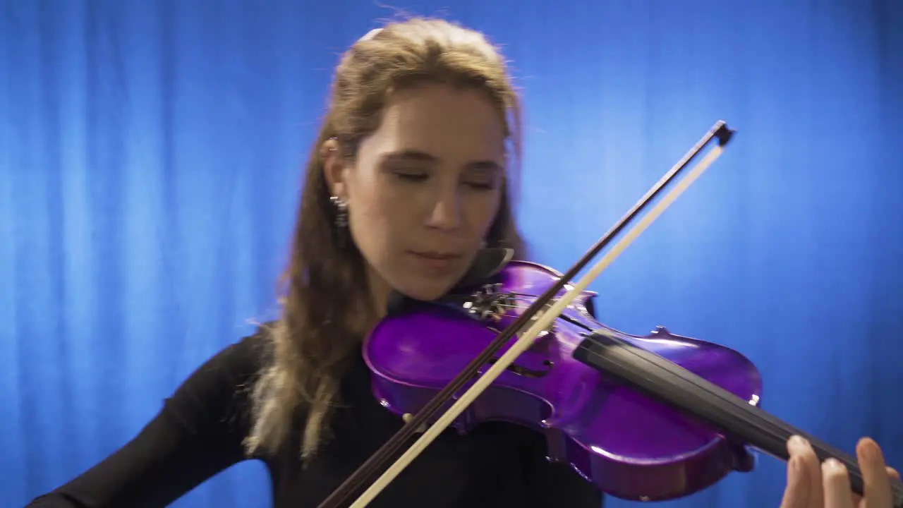 Young musician woman playing violin on stage Opera singer composer