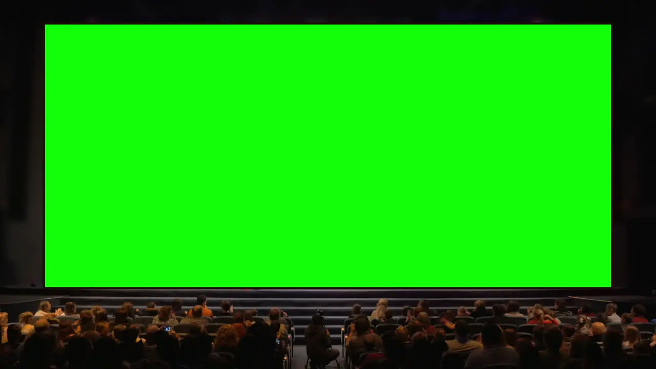 People in the auditorium with chroma key screen