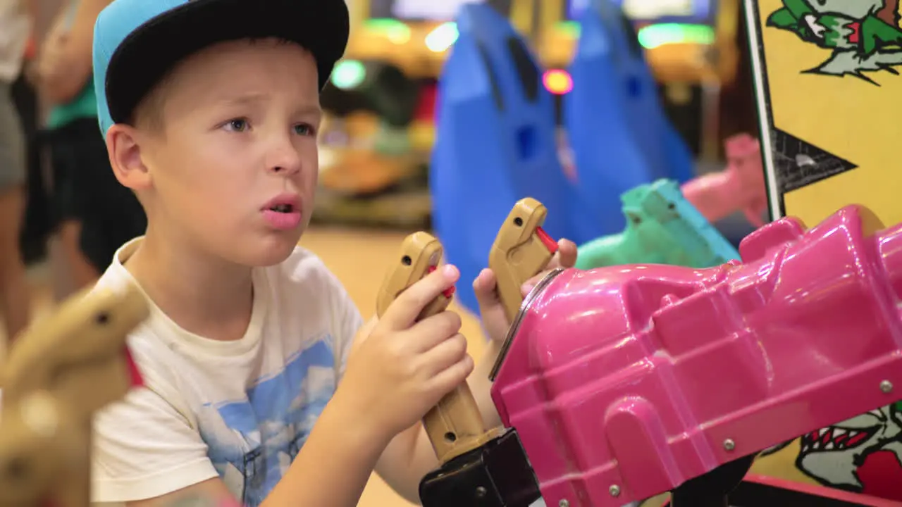 Child having fun with shooter attraction