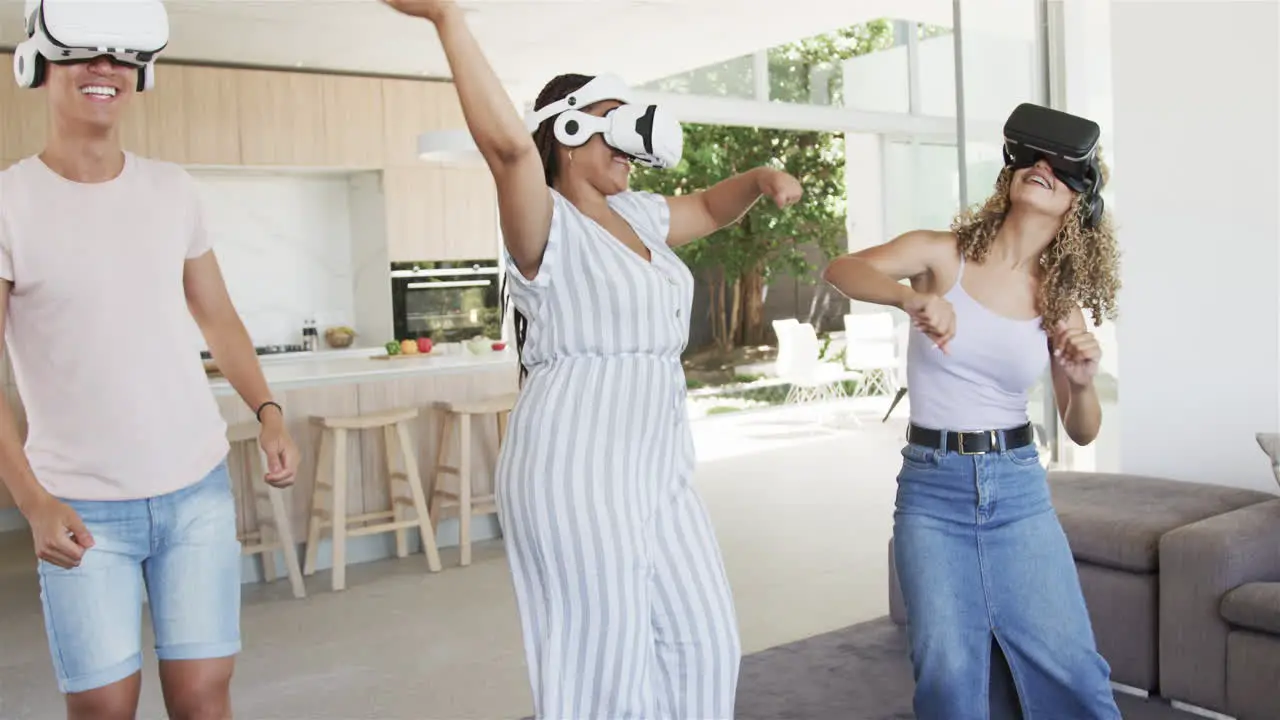 Young Asian man and biracial women enjoy VR games at home