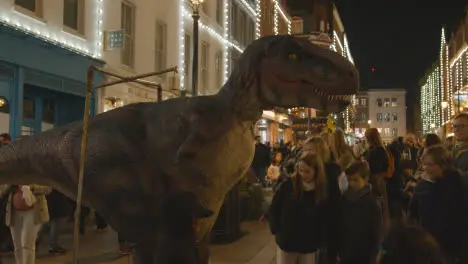 Street Performer Operating Model Dinosaur In Covent Garden London UK At Night 1