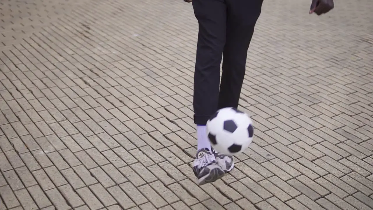 A Young Guy Throws A Soccer Ball With His Feet