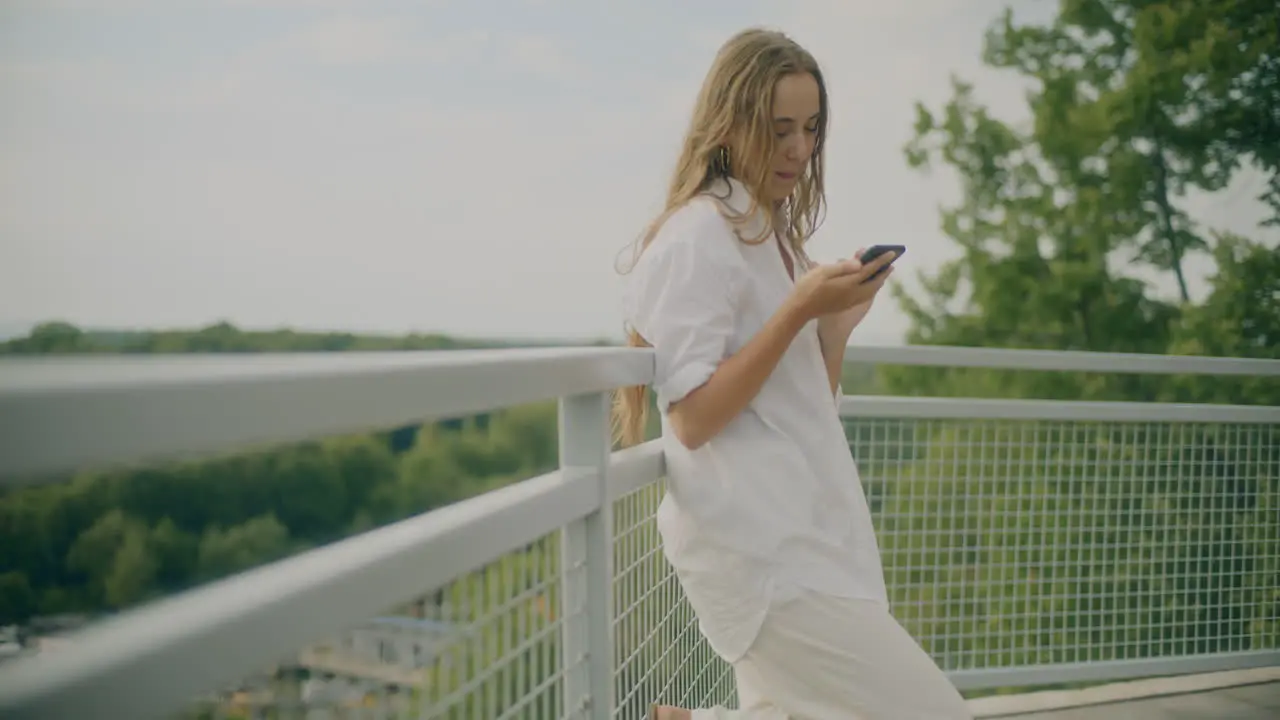 Smiling Woman Browsing Smartphone