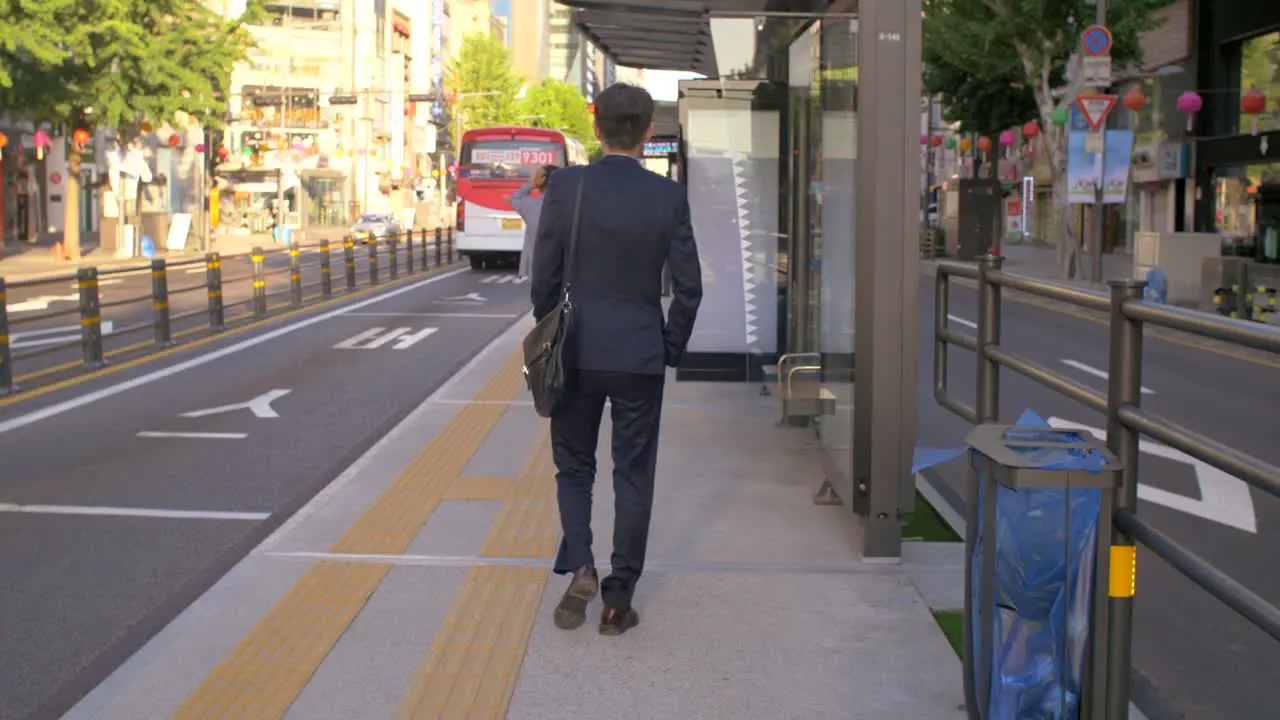 Businessman Walking to Bus Stop