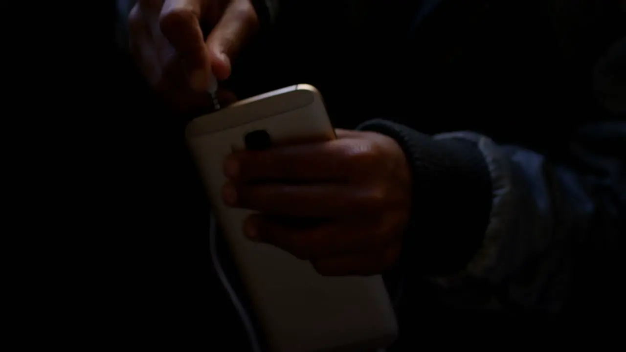 Commuter inserting earphones jack on mobile phone while travelling in bus 4k