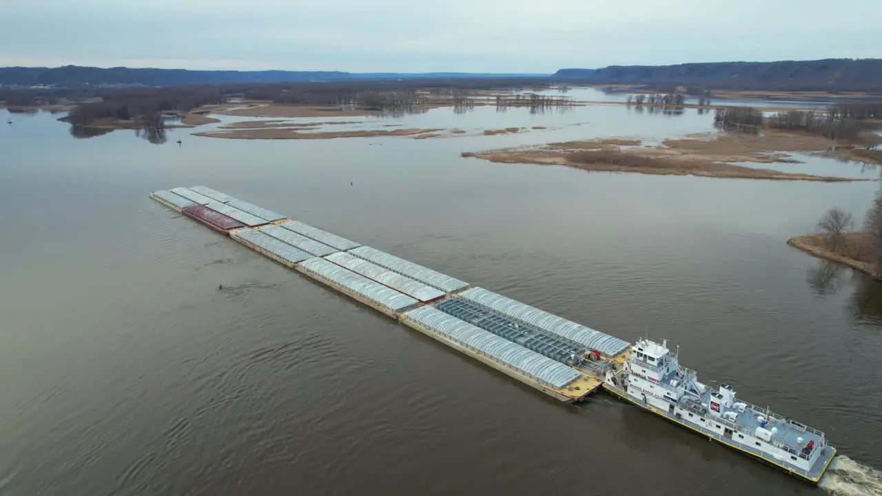 Approaching Lansing Iowa a towboat pushing barges north on the Mississippi River-2