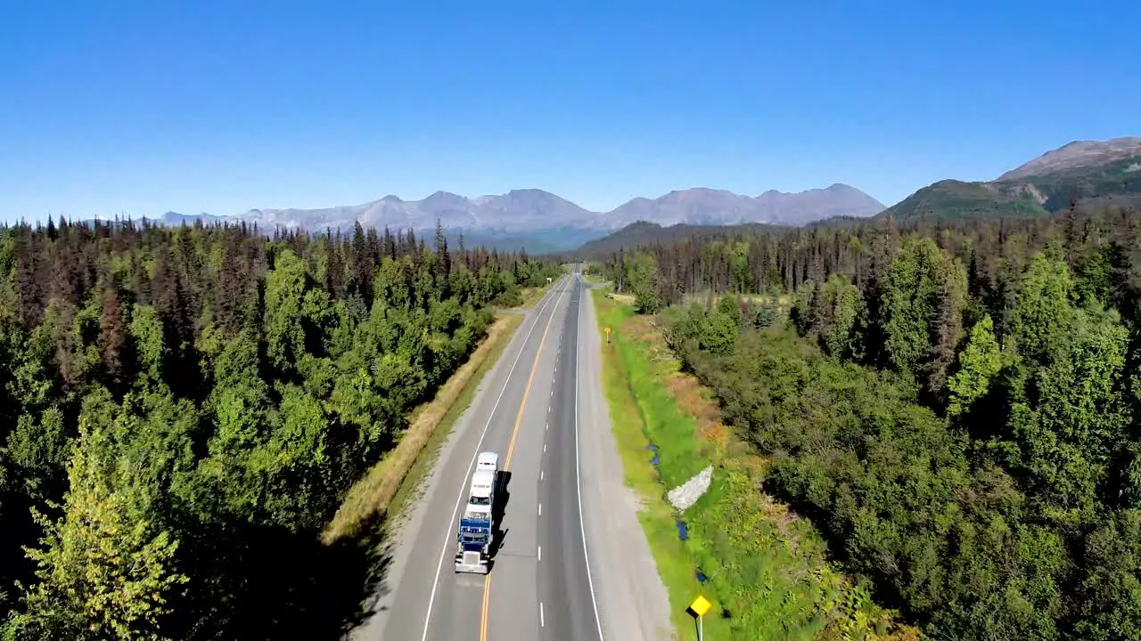 Aerial view of Big truck driving down road in Alaska Interior