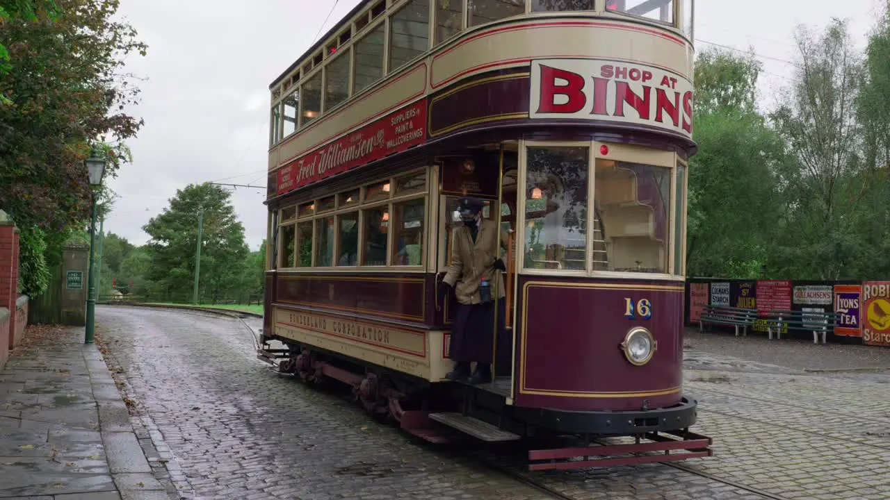 Vintage electrified tram and female conductor at Beamish open air museum