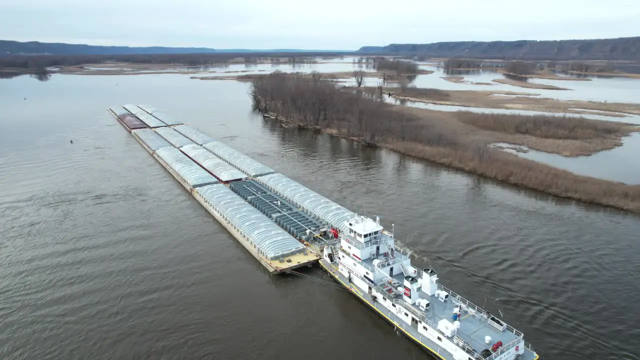 Approaching Lansing Iowa a towboat pushing barges north on the Mississippi River-3