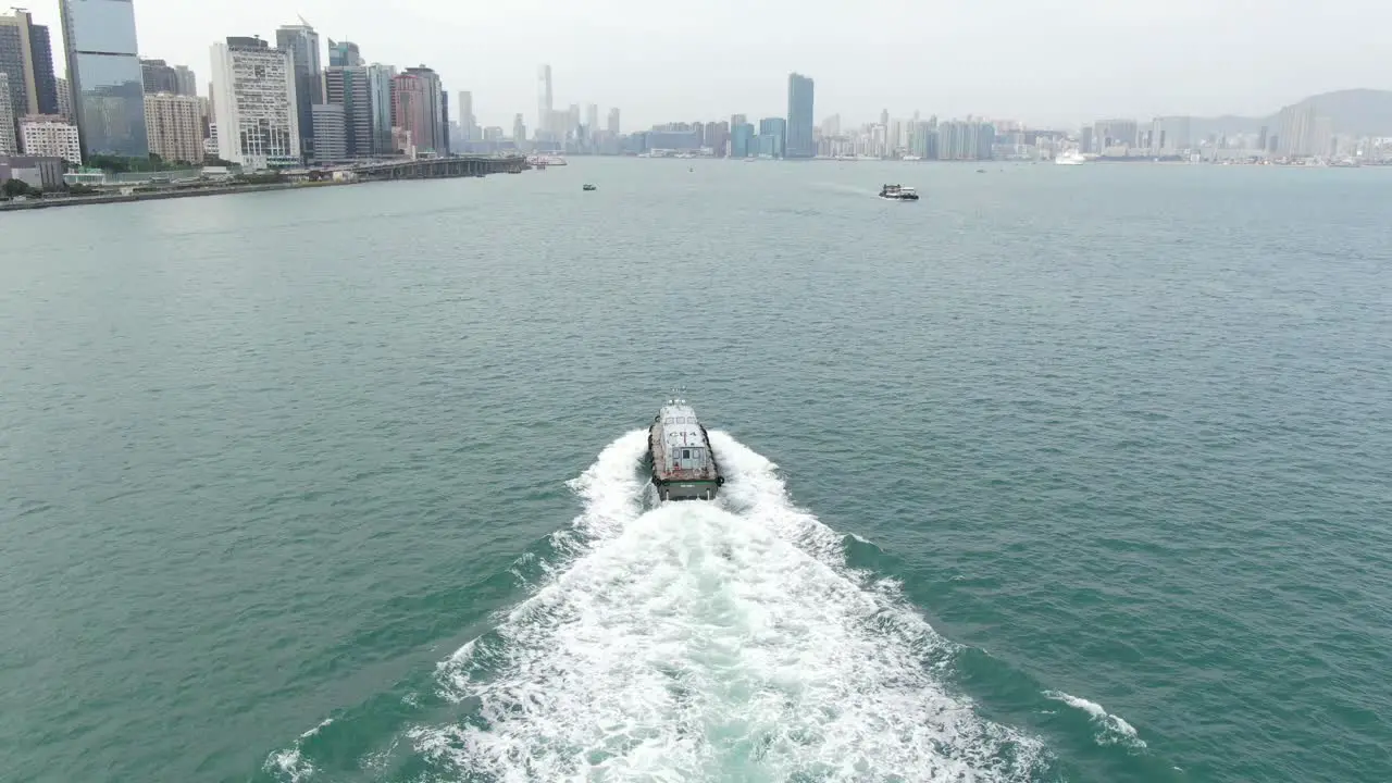 Aerial footage of a Service ship cruising in Hong Kong bay