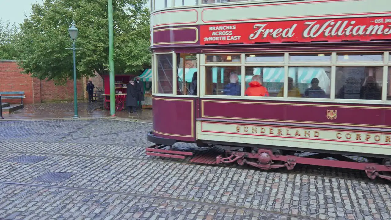 Vintage electrified tram and female at Beamish open air museum