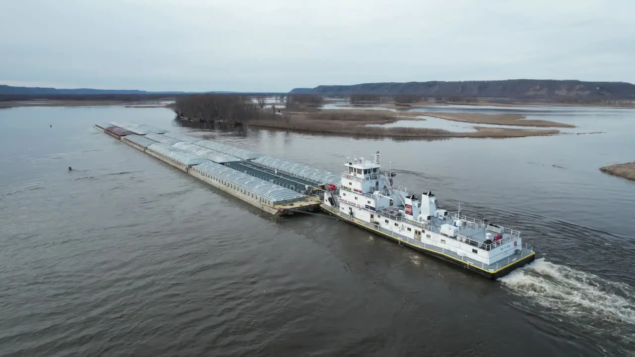 Approaching Lansing Iowa a towboat pushing barges north on the Mississippi River-7