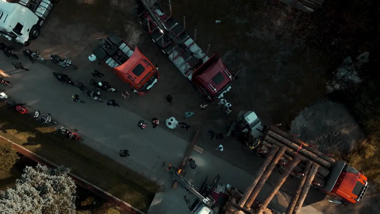 Bird eye view of timber trucks and crane loading tree logs