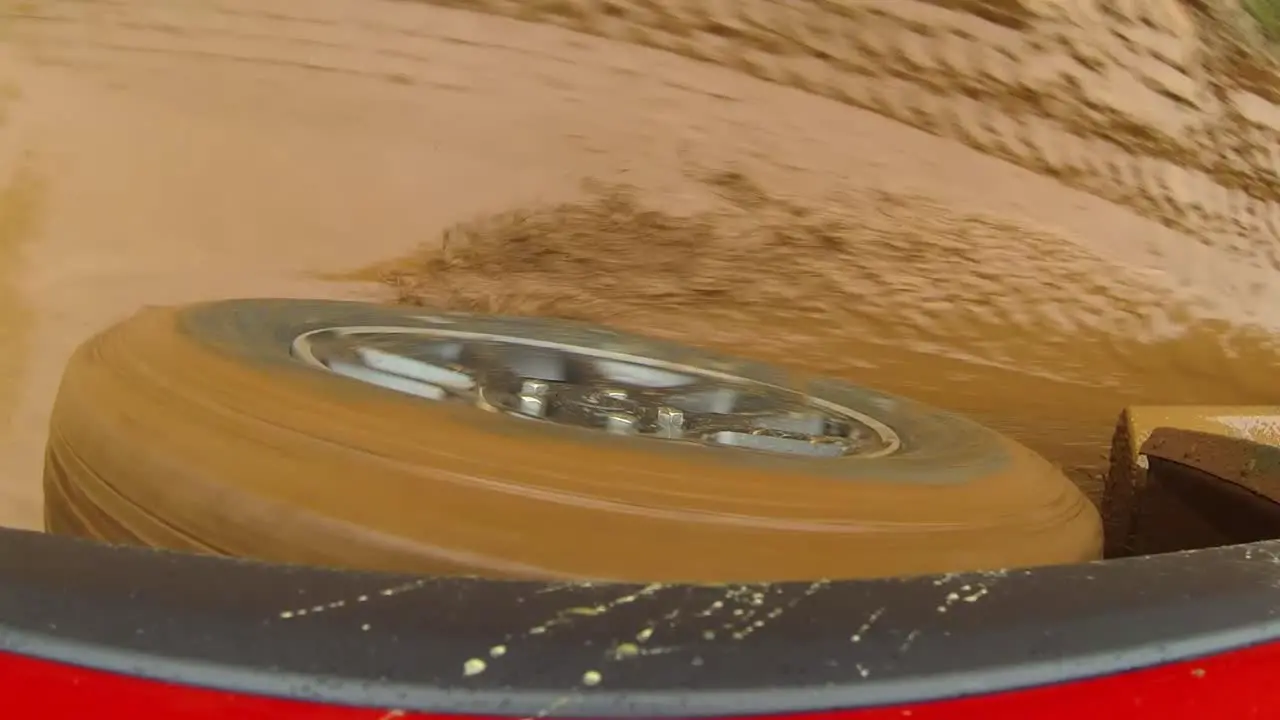 POV of tire moving through mud