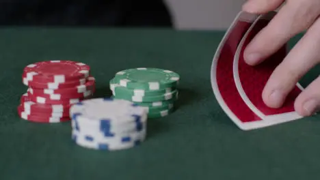 Tracking Close Up Shot from Poker Cards to Chips Being Thrown In 