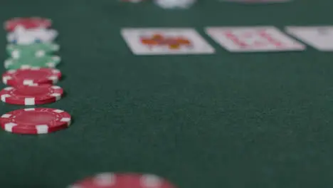 Tracking Close Up Shot from Cards to Poker Chips Being Thrown In 