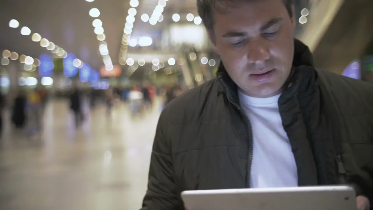 Young man working with touch pad at the airport